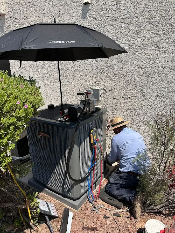 HVAC technician performing outdoor AC maintenance in Rhinebeck