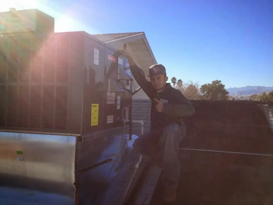 HVAC technician performing Air Duct Cleaning on a rooftop unit in Rhinebeck